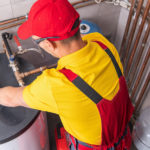 professional plumber checking water heater